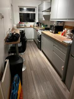 Modern galley kitchen with gloss grey cabinets,...