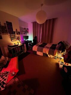 Warm, cozy bedroom with a comfortable single be...