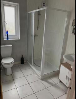 A bright and tidy bathroom featuring a spacious...