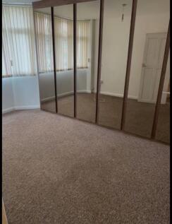 A spacious and well-lit double bedroom featurin...