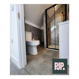 A modern and stylish bathroom featuring a spaci...