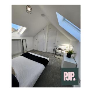 A bright and spacious double bedroom featuring ...