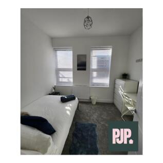 A bright and spacious double bedroom with moder...