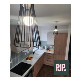 A modern and stylish kitchen featuring ample st...