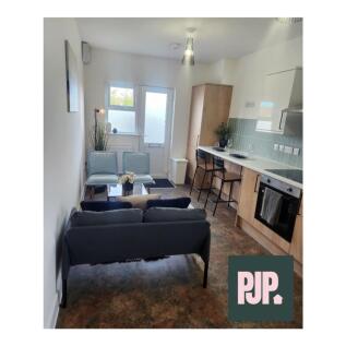 A modern kitchen with ample space and natural l...