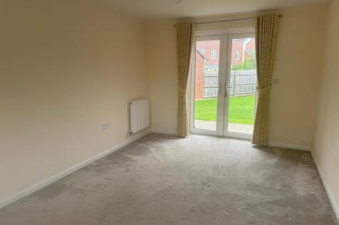 Bright ground-floor living room with full-heigh...