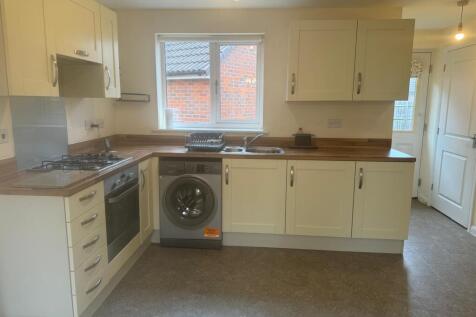 Bright, modern kitchen with fitted cabinets, wo...