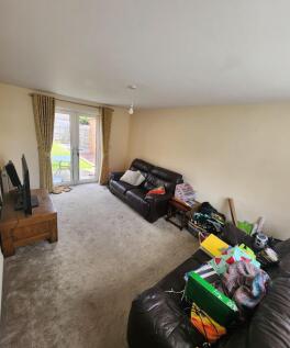 Bright living room with glass doors opening to ...