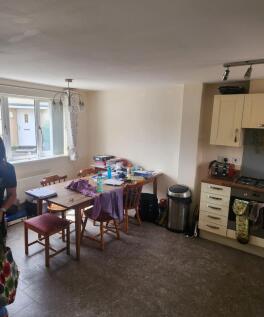 Bright kitchen/dining area with a wooden table ...