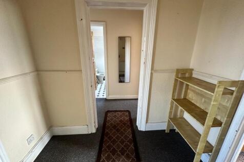 Bright hallway with neutral walls, fitted skirt...