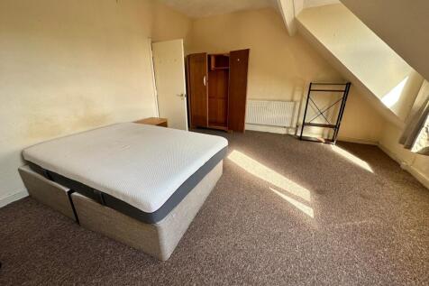 Bright, well-lit bedroom with a double bed on a...