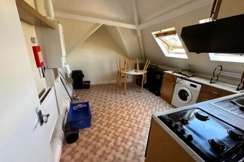 Bright attic-style kitchen with sloped ceilings...