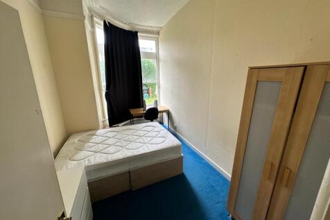 Bright bedroom with a comfortable double bed, w...