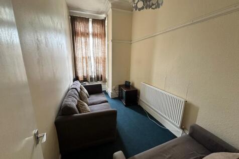 Long, narrow living room with two comfortable s...
