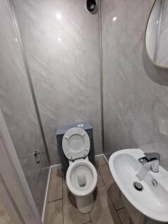 Compact modern WC with a white toilet and basin...
