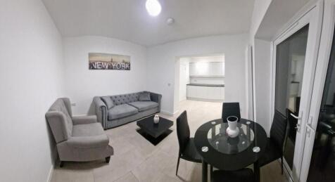 Bright, modern open-plan living room with grey ...