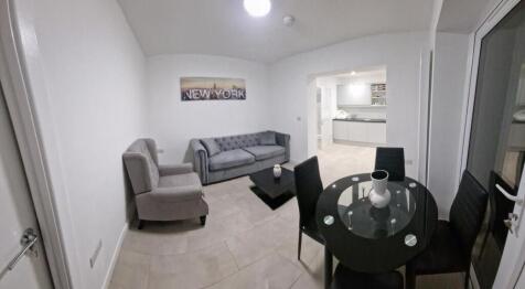 Bright, modern living area with a comfy upholst...