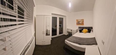 Bright, modern bedroom with a double bed dresse...