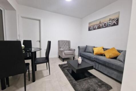 Bright, modern living room with a comfortable g...