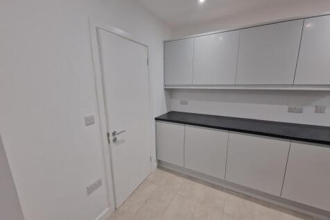 Modern, minimalist kitchen with sleek handleles...