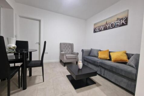 Bright, modern living room with a comfortable g...