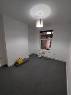 Bright, freshly painted bedroom with neutral ca...