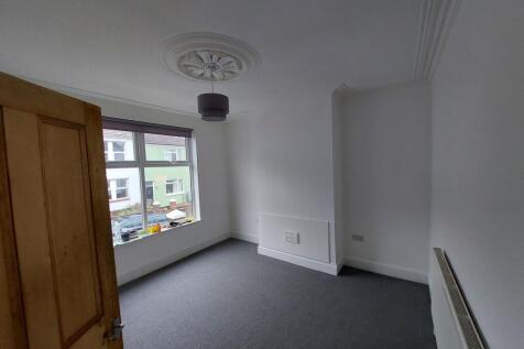 Bright, freshly painted bedroom with a large fr...