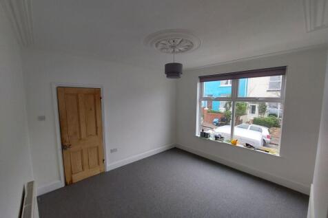 Bright, freshly painted bedroom with large fron...