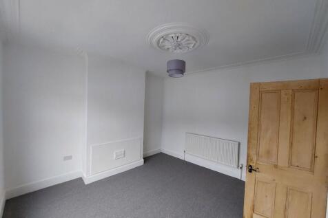 Bright, neutral bedroom with fresh white walls,...