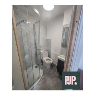 A modern bathroom suite featuring a spacious sh...