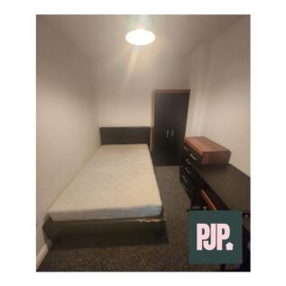 This inviting double bedroom features a comfort...