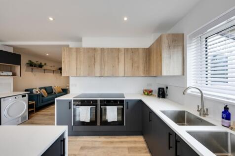 A modern kitchen with clean lines, bright light...