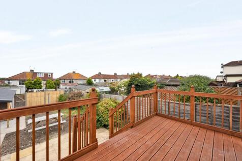 Well-maintained wooden deck overlooking a priva...