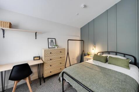 A well-decorated double bedroom featuring a bed...