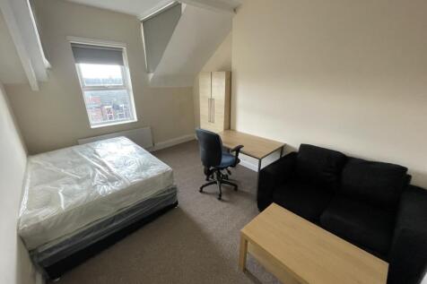Spacious double bedroom featuring a comfortable...