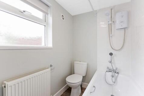 A stylish and modern bathroom featuring a sleek...