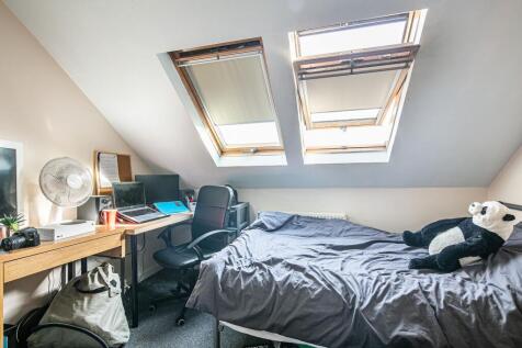Bright attic double bedroom with two skylights,...