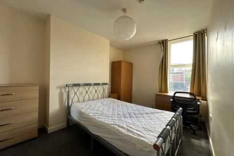 Bright, neutrally decorated double bedroom with...