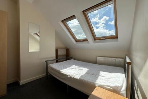 Bright attic double bedroom with two skylight w...