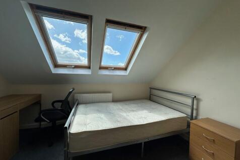 Bright double bedroom in a loft with two large ...