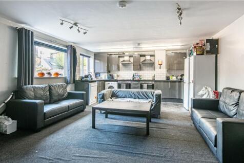 Bright open-plan living area with modern grey s...