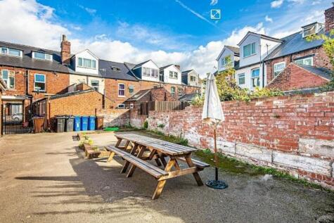 Private communal paved courtyard with picnic be...