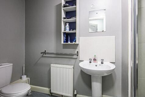 Well-maintained bathroom with a pedestal sink, ...