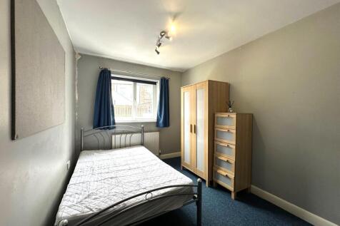 Neat double bedroom with a metal bedframe, larg...