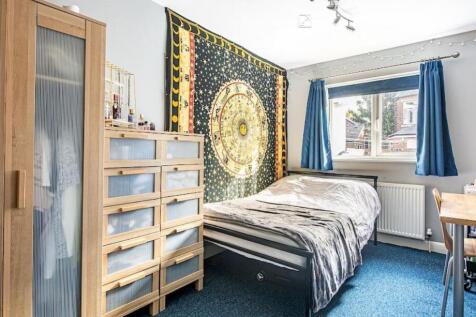 Bright, welcoming bedroom with a comfortable do...