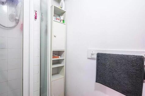 A clean and simple bathroom area with a glass s...