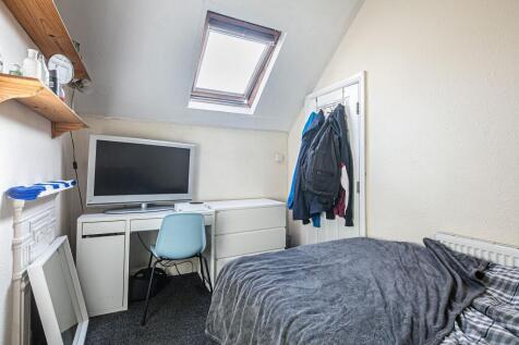 Cosy attic-style bedroom with a skylight, compa...