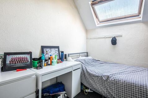 Bright attic single bedroom with a skylight, ti...