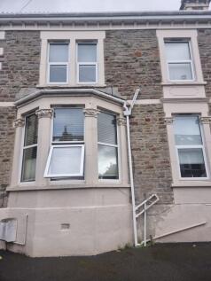 Stone-front terraced house with decorative bay ...
