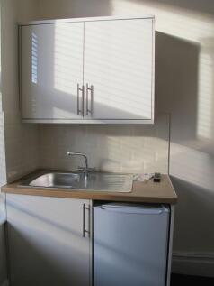 Compact modern kitchenette with a stainless-ste...